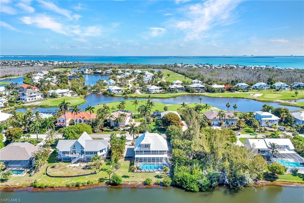 Image 4: Coastal community featuring multiple properties, water frontage, and golf course access
