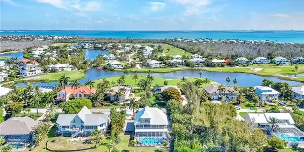 Image 4: Coastal community featuring multiple properties, water frontage, and golf course access