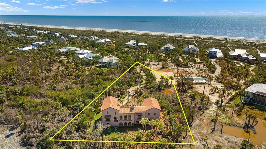 Image 3: Aerial perspective of suburban area with expansive coastline and property parcel outlined