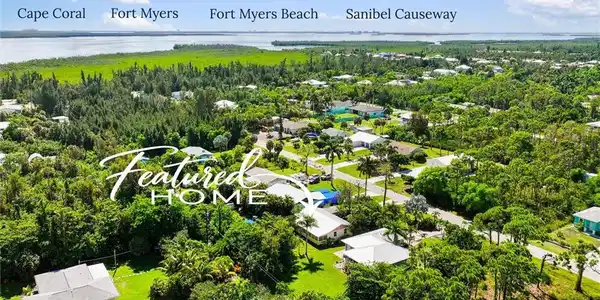 Image 4: Aerial view from the property toward Cape Coral, Fort Myers, Fort Myers Beach and the Sanibel Causeway, illustrating the home&rsquo;s connection to some of Southwest Florida&rsquo;s most recognizable destinations.