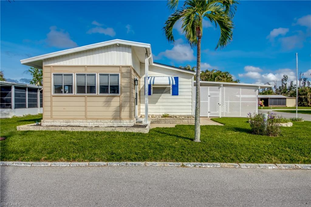 Image 2: View of front facade featuring a front yard