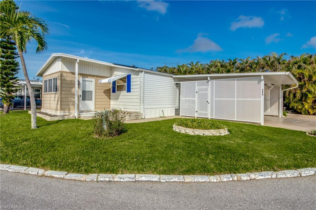 Image 3: View of front of house featuring a front yard and a carport