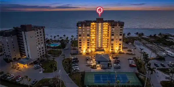 Image 2: Aerial View of Caper Beach Club on Gulf at Dusk