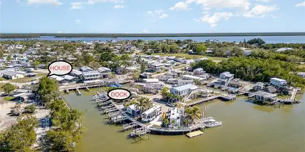 Image 3: Aerial view of property's location with a nearby body of water