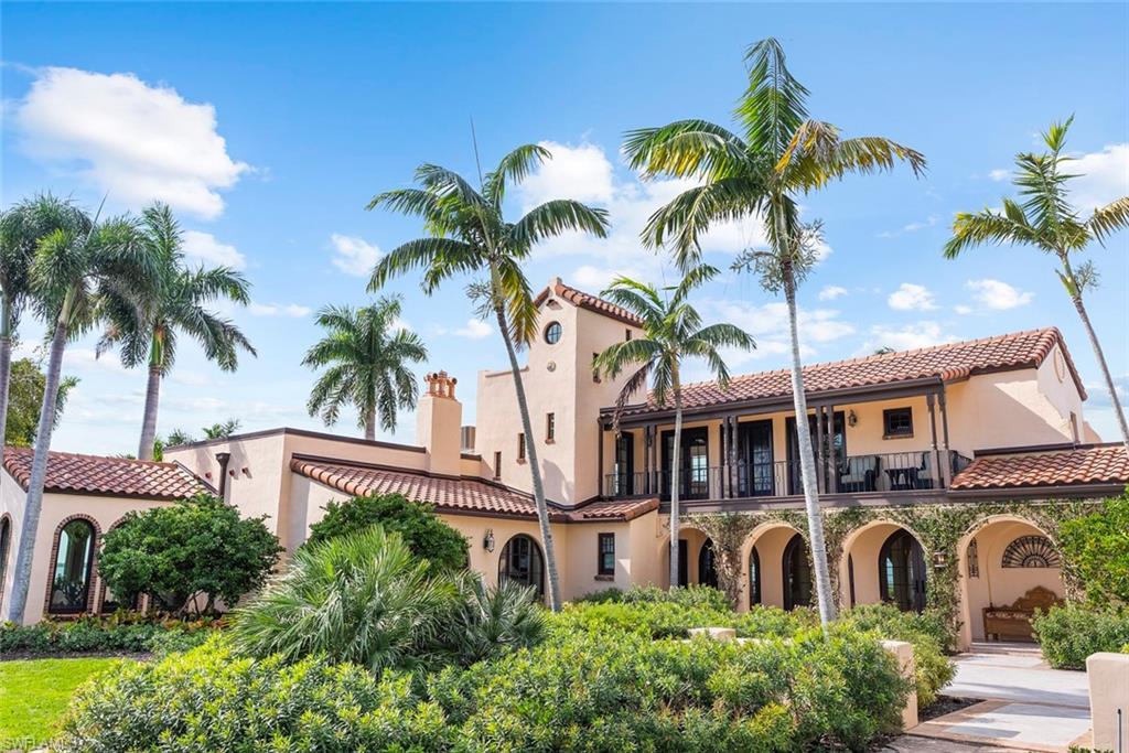 Image 3: MAIN HOUSE - The property features a Mediterranean-style exterior with arched walkways, terra cotta roof tiles, and an upper-level balcony