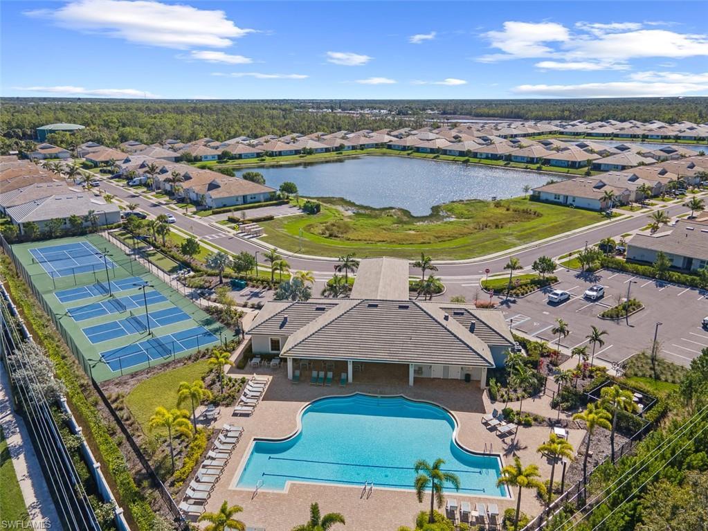 Image 3: Aerial perspective of suburban area with a pool and a nearby body of water