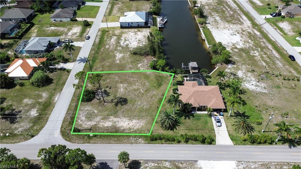 Image 1: Vacant corner lot featuring mature trees and street frontage