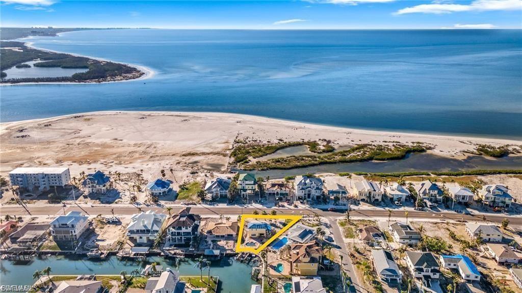 Image 2: Aerial perspective of suburban area featuring a large body of water