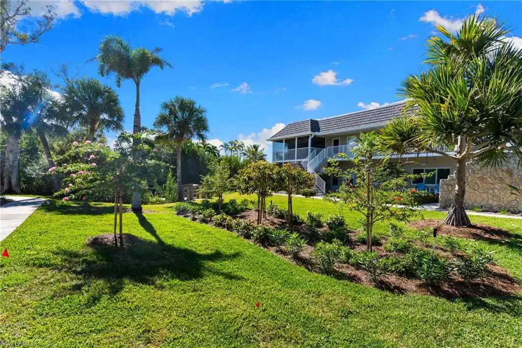 Image 1: View of green lawn featuring a balcony and stairway