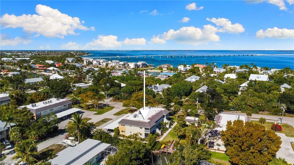 Image 3: Aerial view of property and surrounding area featuring a nearby body of water