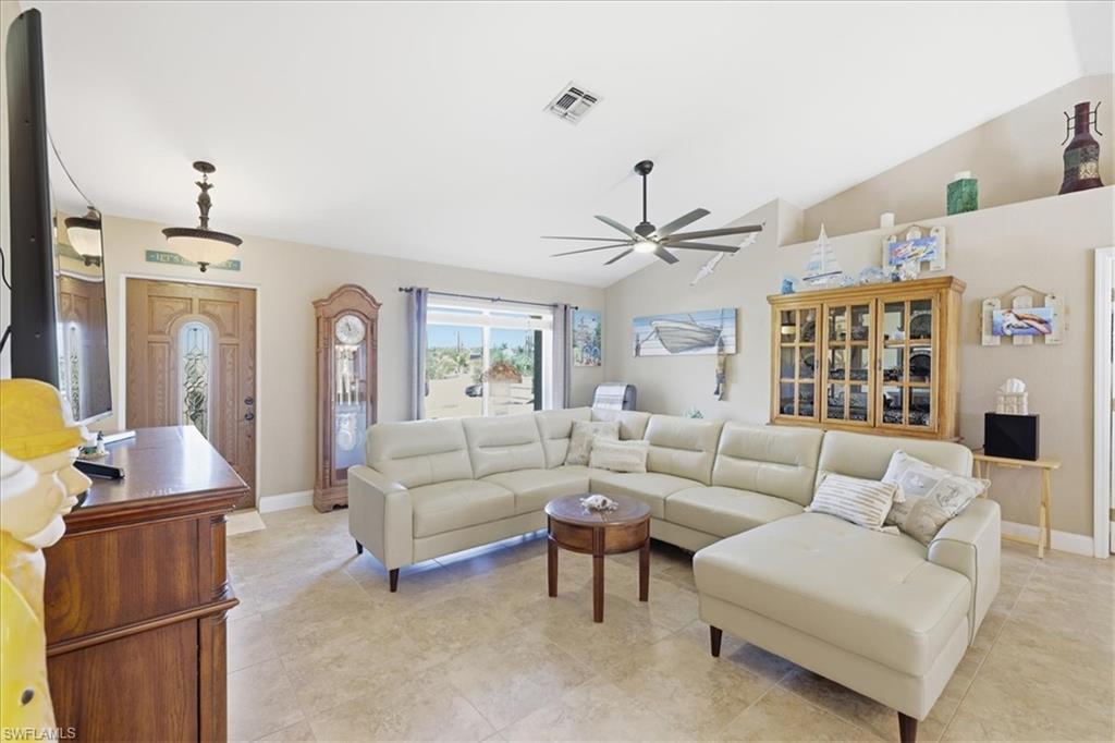 Image 4: Living room with lofted ceiling and ceiling fan