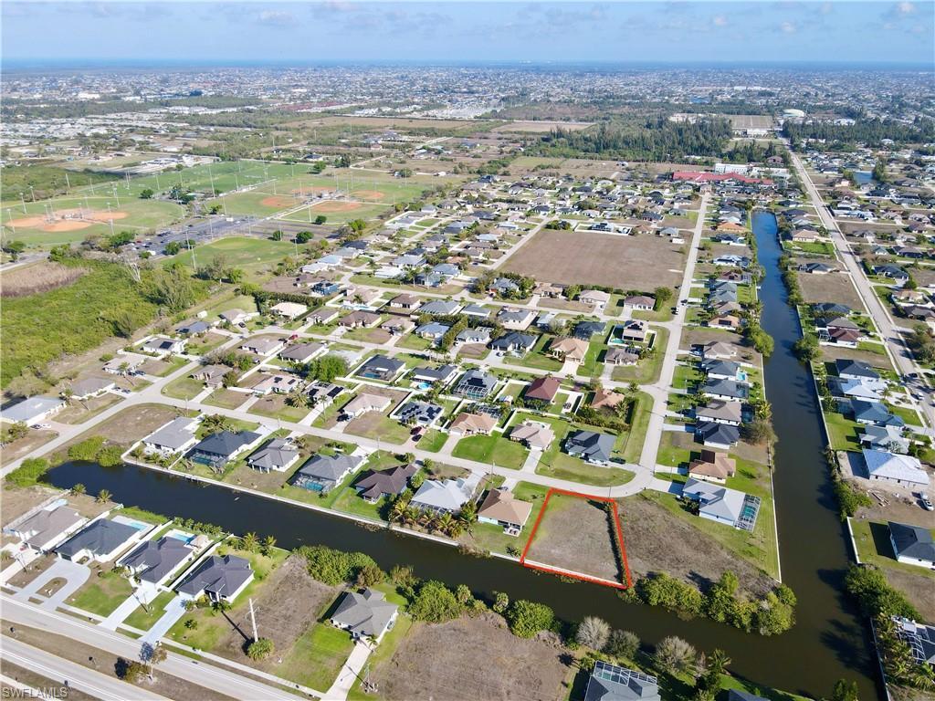 Image 1: View of property location with nearby suburban area and a nearby body of water