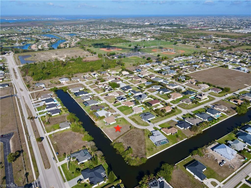 Image 4: View of property location with a nearby body of water and nearby suburban area
