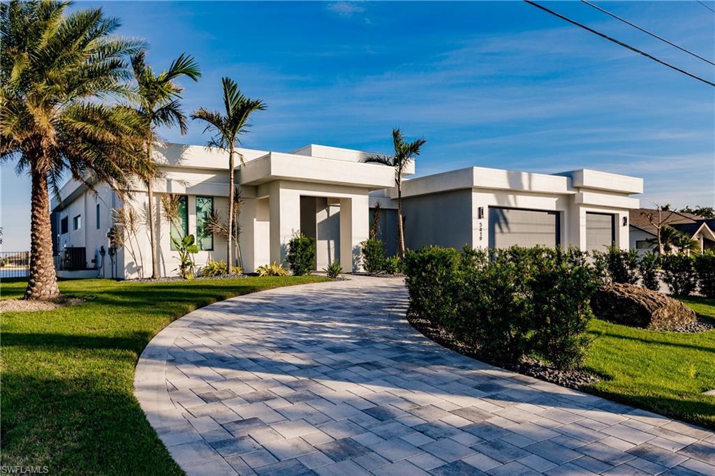 Image 4: Contemporary home featuring stucco siding and a front yard