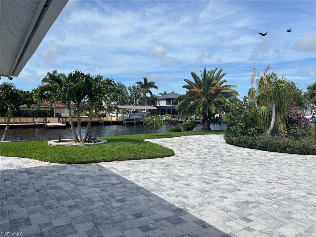 Image 2: View of property's community featuring a yard and a water view