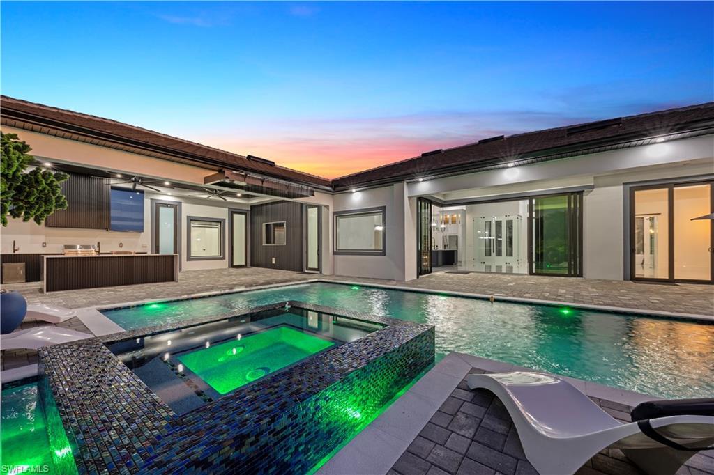 Image 3: View of pool featuring a patio and a pool with connected hot tub