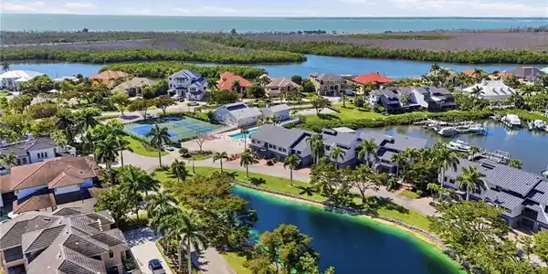 Image 3: Aerial view of residential area with a nearby body of water