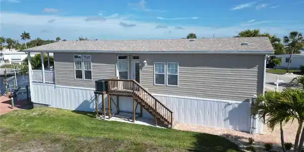 Image 2: View of front of house with a front yard and stairway