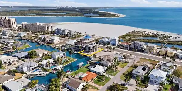 Image 3: Aerial perspective of suburban area with a nearby body of water - Virtually Edited Image