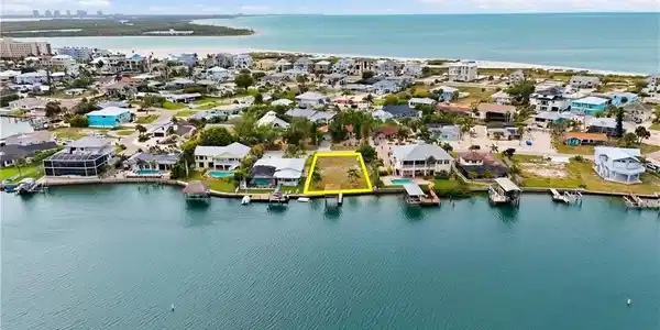 Image 2: Aerial perspective of suburban area with a large body of water - Virtually Edited Image