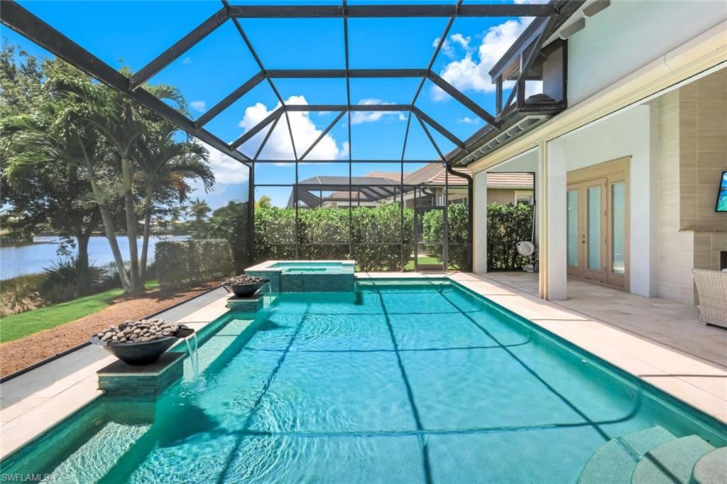 Image 4: Peaceful pool setting featuring water and fire bowls