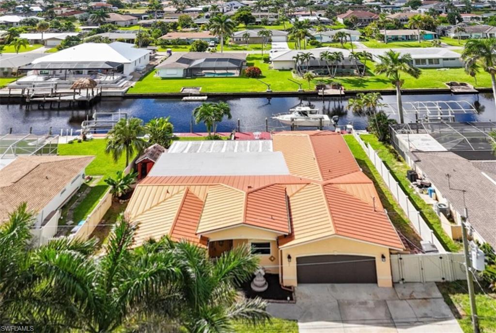 Image 4: Aerial view of residential area with a large body of waterDirect Gulf Access Waterfront home, minutes to open water!