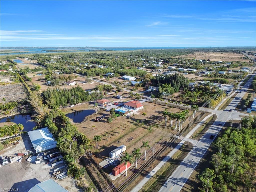 Image 2: Aerial view of property and surrounding area with a large body of water