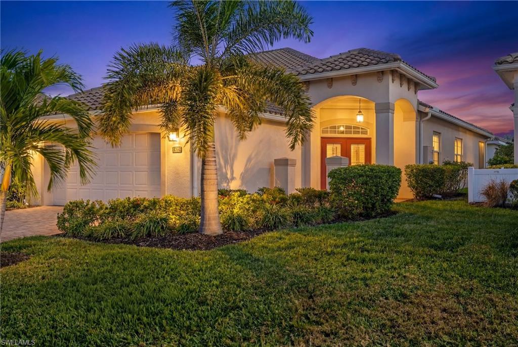 Image 2: Mediterranean / spanish-style house featuring stucco siding, french doors, a garage, a yard, and driveway