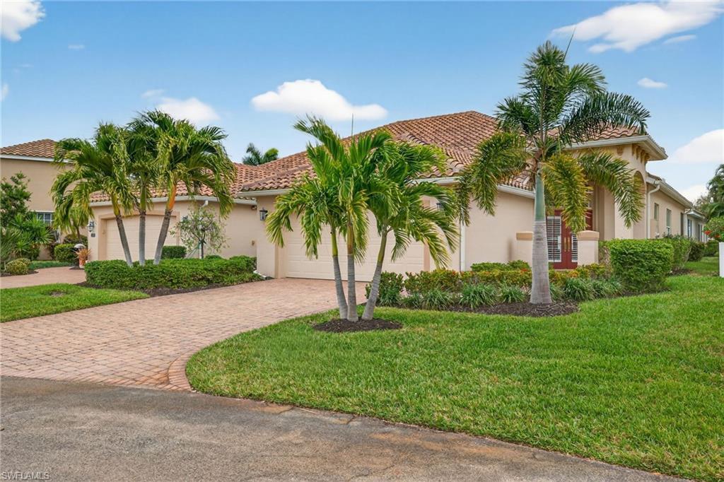 Image 4: Mediterranean / spanish house with stucco siding, a front yard, decorative driveway, and a tiled roof