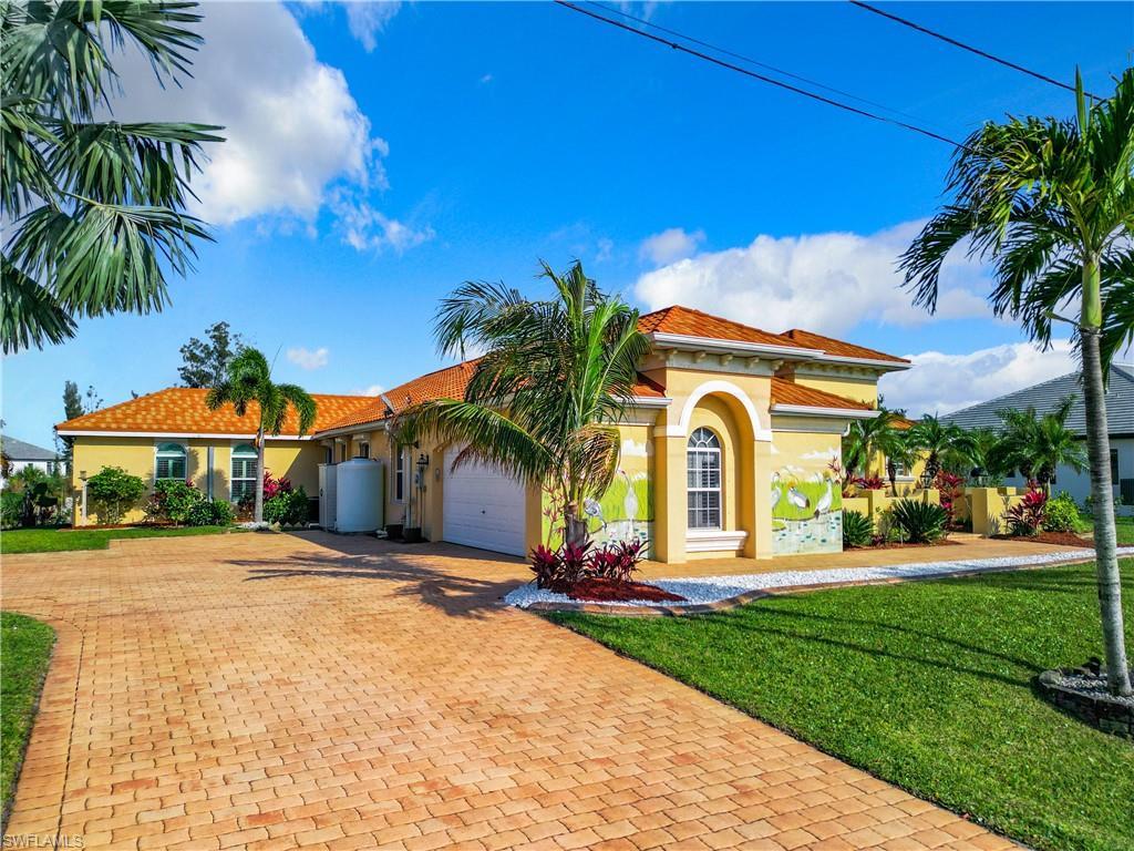 Image 2: Mediterranean / spanish house with a front yard, stucco siding, decorative driveway, and a garage