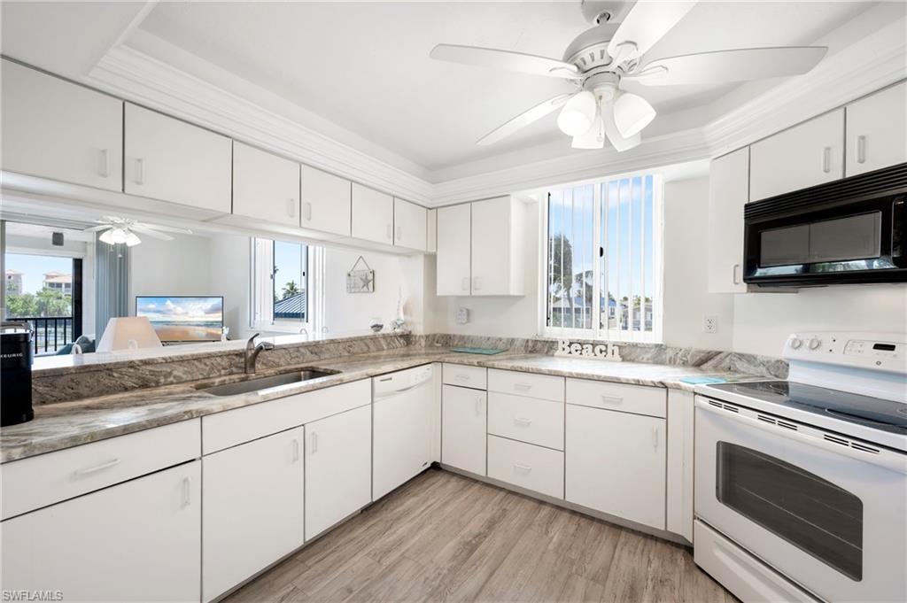 Image 4: Kitchen featuring ceiling fan, white appliances, white cabinetry, and plenty of natural light
