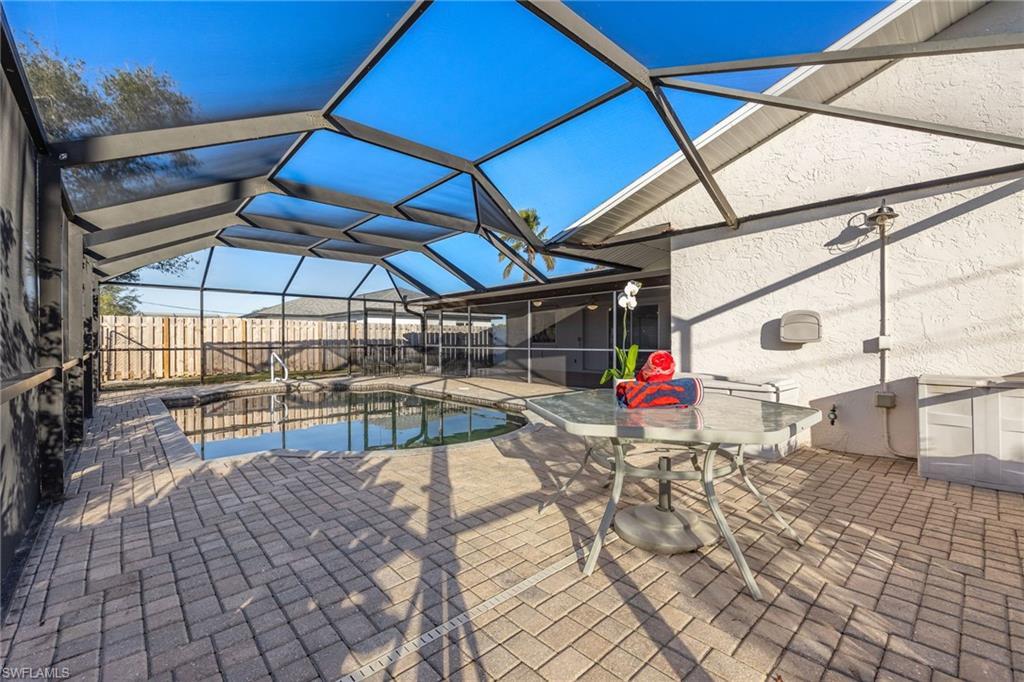 Image 3: View of pool with a lanai and a patio area