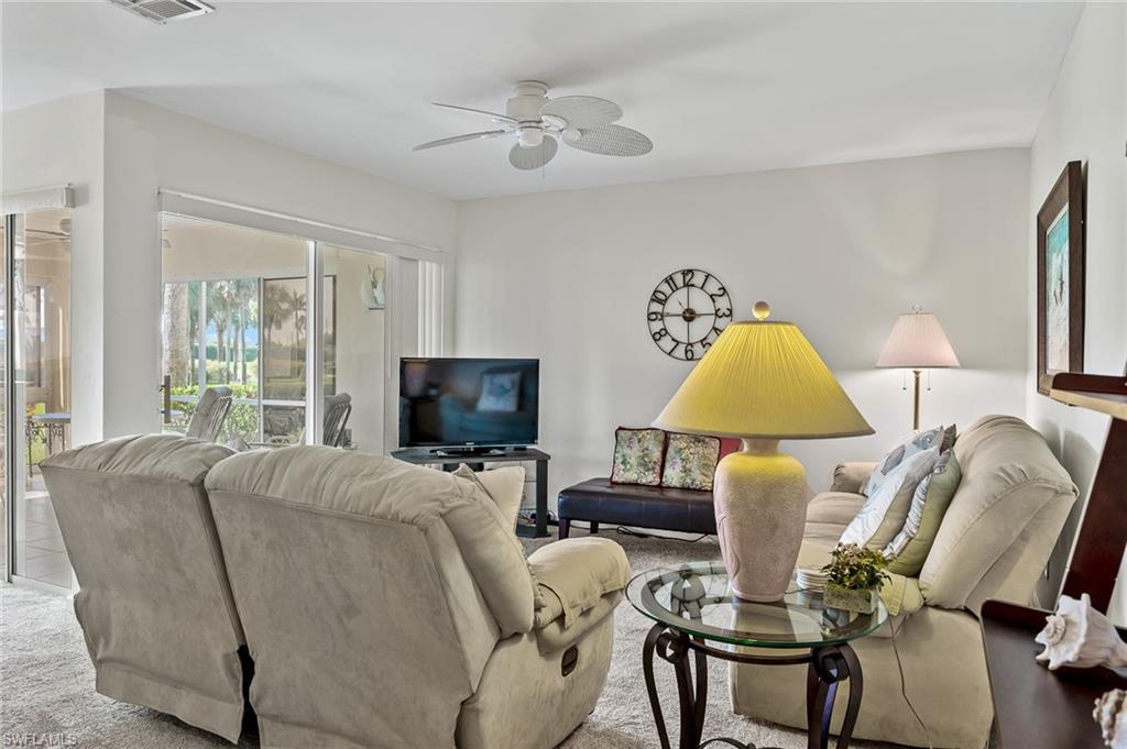 Image 3: Living area featuring carpet flooring, visible vents, and ceiling fan