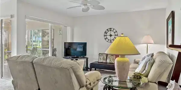 Image 3: Living area featuring carpet flooring, visible vents, and ceiling fan