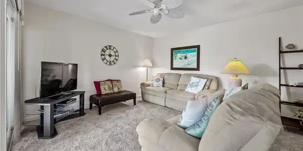 Image 4: Living room with carpet and a ceiling fan