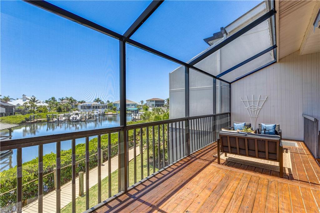 Image 2: Screened lanai with marina and  water views.