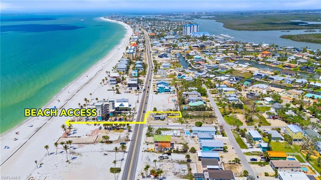 Image 1: Birds eye view of property with a beach view and a water view  - Virtually Edited Image