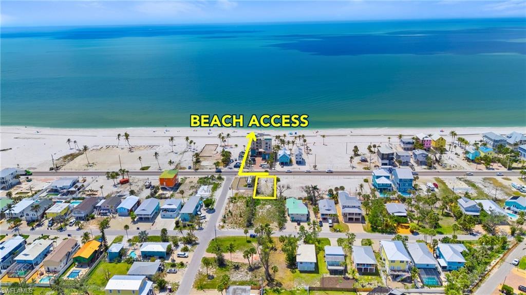 Image 3: Birds eye view of property featuring a water view, a residential view, and a view of the beach  - Virtually Edited Image