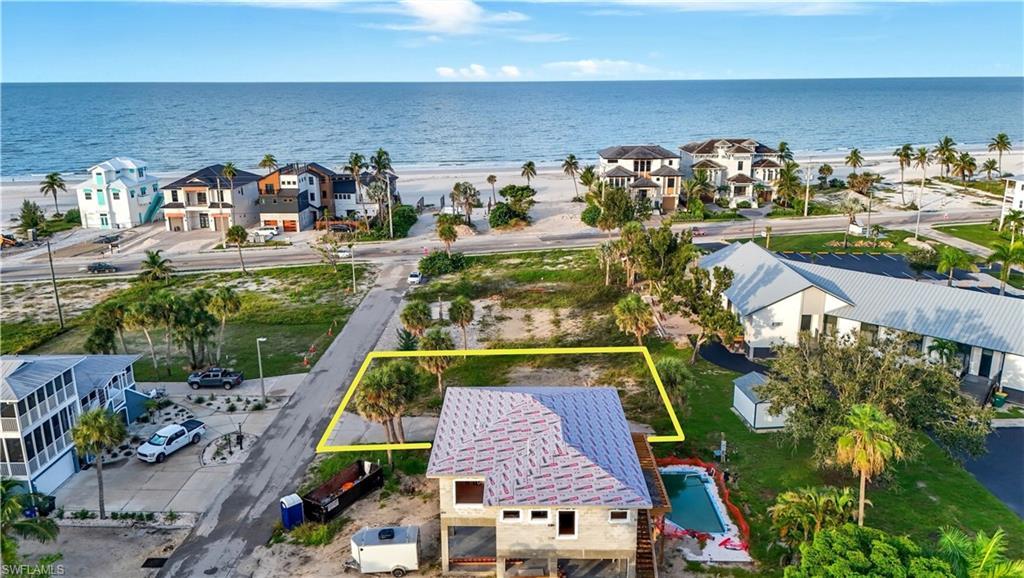 Image 3: Aerial view of residential area featuring extended coastline and property boundaries highlighted - Virtually Edited Image