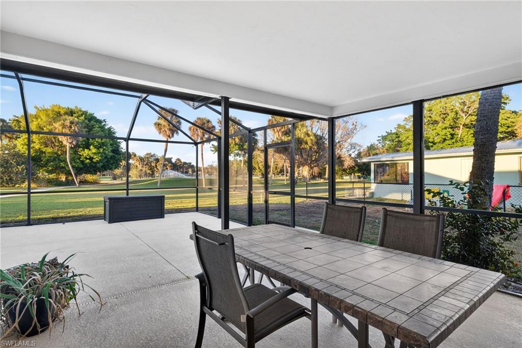 Image 2: Spacious screened-in patio featuring a concrete floor, white ceiling, and expansive outdoor exposure