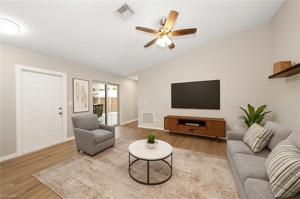 Image 2: Bedroom with multiple closets, light tile patterned floors, and a ceiling fan
