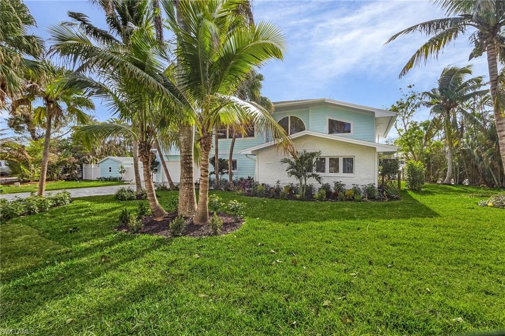 Image 2: View of front of house featuring a front lawn