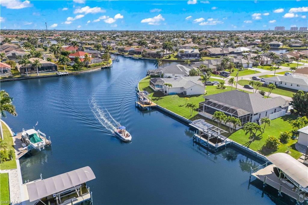 Image 2: Aerial perspective of suburban area with a nearby body of water