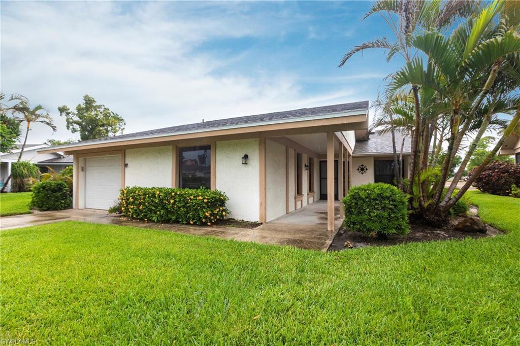 Image 2: Ranch-style home featuring stucco siding, a front yard, a garage, and a shingled roof