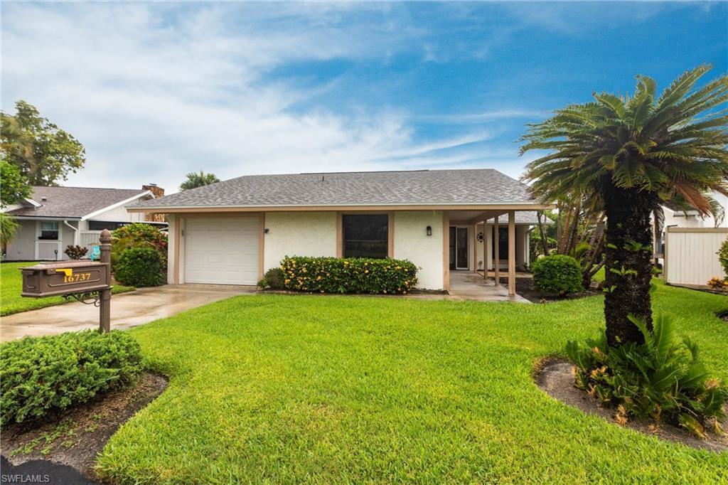 Image 3: Ranch-style home featuring stucco siding, a shingled roof, concrete driveway, and a front yard