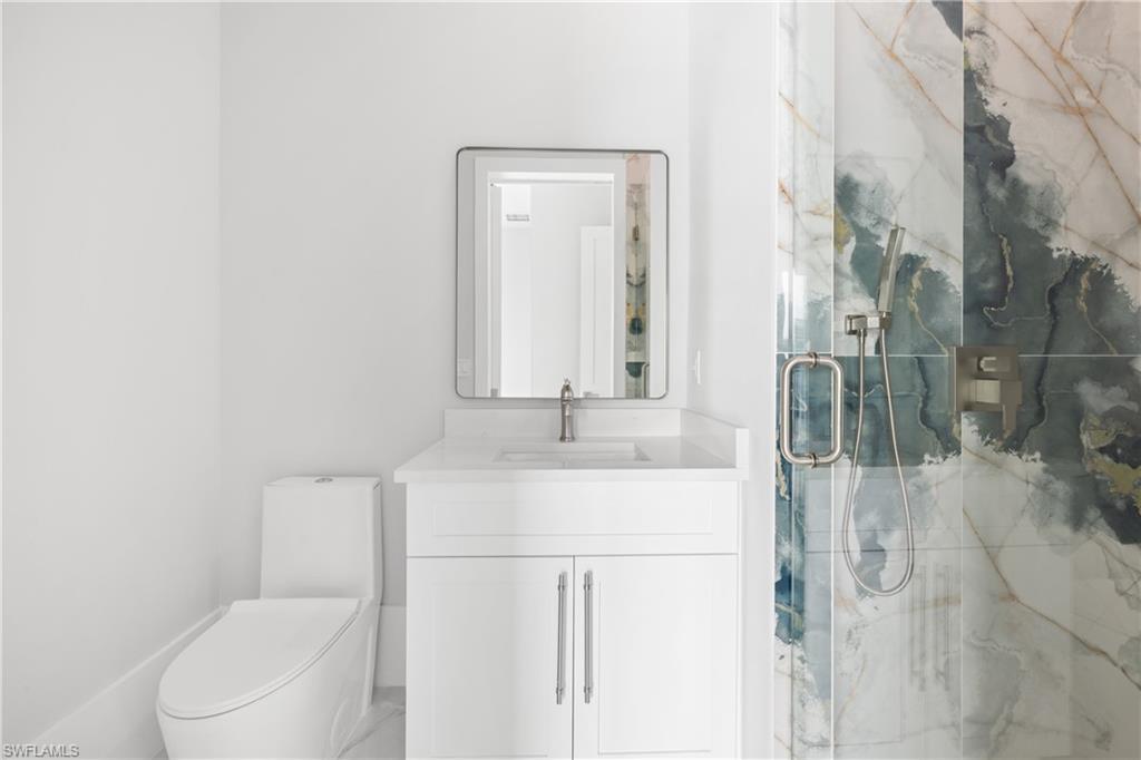Image 1: Full bathroom featuring a marble finish shower and vanity
