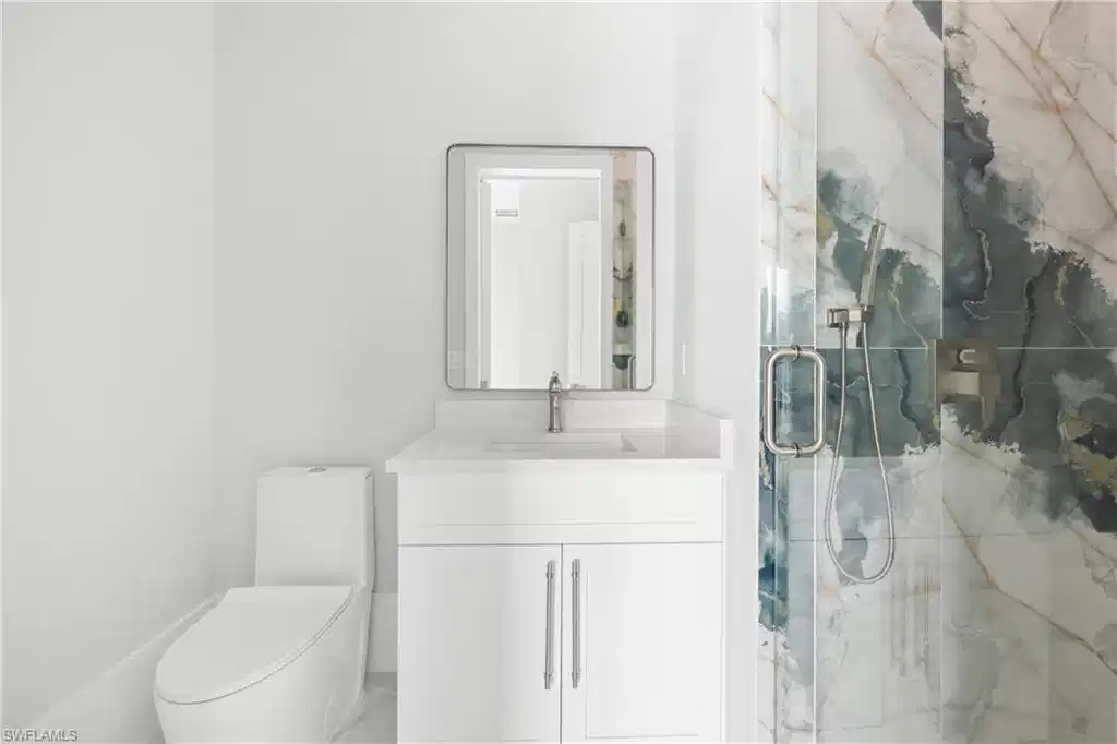 Image 1: Full bathroom featuring a marble finish shower and vanity