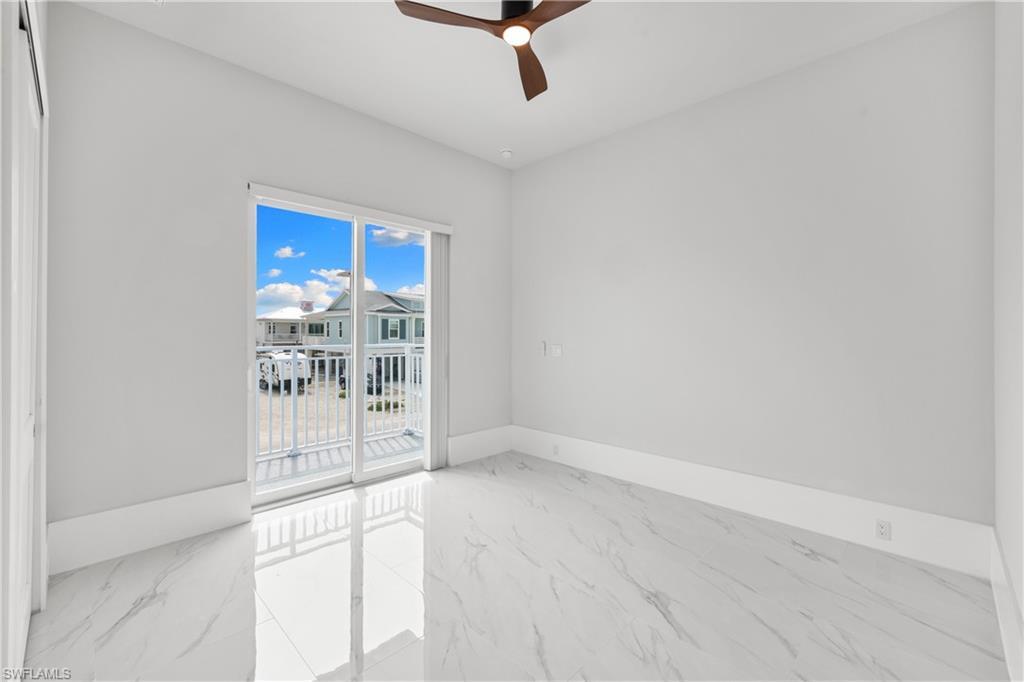 Image 3: Empty room with light marble finish flooring and a ceiling fan