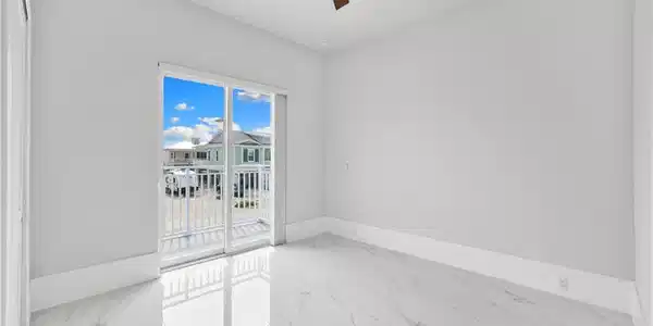 Image 3: Empty room with light marble finish flooring and a ceiling fan