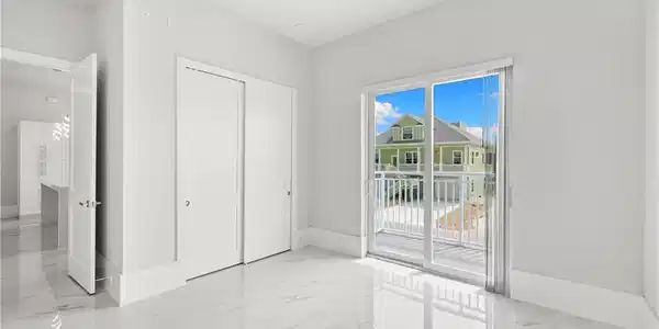 Image 4: Unfurnished bedroom featuring light marble finish floors, a closet, access to exterior, and a ceiling fan